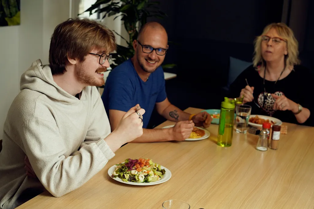 Team members enjoying lunch together in the office lounge