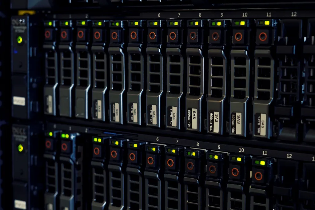 Server rack with multiple SAS hard drives, showing active status lights