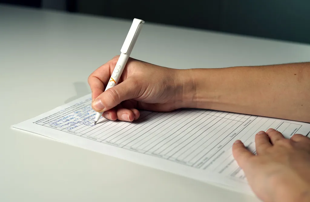 A trainee filling out an old paper training record